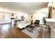Spacious open concept living room with hardwood floors, fireplace, and a kitchen view at 5135 N Kenwood Ave, Indianapolis, IN 46208