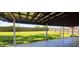 Covered backyard patio, perfect for entertaining with views of a flat, grassy yard and privacy fence at 5444 S Holiday Dr, Columbus, IN 47203