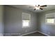 Cozy bedroom featuring neutral walls, a ceiling fan, and double-hung windows for natural light at 5444 S Holiday Dr, Columbus, IN 47203