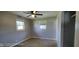 Bedroom with neutral paint and trim, double hung windows, ceiling fan and carpet at 5444 S Holiday Dr, Columbus, IN 47203
