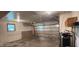 Spacious garage with garage door, lots of natural light, and painted walls at 5444 S Holiday Dr, Columbus, IN 47203