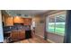 Functional kitchen featuring wood cabinets and a view of the backyard at 5444 S Holiday Dr, Columbus, IN 47203
