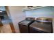 A convenient laundry room with modern front load washer and dryer and plenty of space at 5444 S Holiday Dr, Columbus, IN 47203