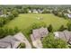 Aerial view of a residential property showcasing a well-manicured lawn, a two-car garage, and a basketball court at 5698 Kenderly Ct, Carmel, IN 46033