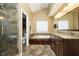 Bathroom featuring a large tub, dual vanities with granite countertops, and a glass-enclosed shower at 5698 Kenderly Ct, Carmel, IN 46033