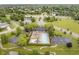 Beautiful aerial view of a community pool with mature landscaping, lakes, and neighborhood streets at 5698 Kenderly Ct, Carmel, IN 46033