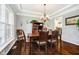 Dining room with hardwood floors, crown molding, and chandelier lighting at 5698 Kenderly Ct, Carmel, IN 46033