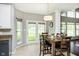 Inviting dining area with a wood table, chair seating, stylish lighting and French doors that let in lots of natural light at 5698 Kenderly Ct, Carmel, IN 46033