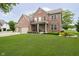Charming brick two-story home with landscaped front yard and covered entryway at 5698 Kenderly Ct, Carmel, IN 46033