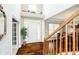 Elegant foyer with hardwood floors, soaring ceilings, and decorative staircase at 5698 Kenderly Ct, Carmel, IN 46033
