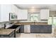 Modern kitchen equipped with stainless steel appliances, granite countertops, and ample natural light from the window at 5698 Kenderly Ct, Carmel, IN 46033