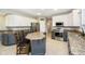 Well-appointed kitchen boasts stainless steel appliances, granite countertops, and a convenient center island with seating at 5698 Kenderly Ct, Carmel, IN 46033