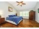 Comfortable main bedroom with hardwood floors, large windows, vaulted ceiling, and a ceiling fan with light at 5698 Kenderly Ct, Carmel, IN 46033