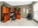Cozy home office space with custom built-in shelving and neutral carpet at 5698 Kenderly Ct, Carmel, IN 46033