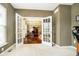 Office area showcasing open French doors leading to the dining room at 5698 Kenderly Ct, Carmel, IN 46033