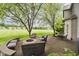 Charming patio with a fire pit, comfortable seating, and a view of the spacious lawn and surrounding landscape at 5698 Kenderly Ct, Carmel, IN 46033