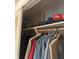 A closet shelf featuring hats and shirts hanging below at 5774 N Ewing St, Indianapolis, IN 46220