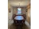 Traditional dining room with a wooden table, chairs, and classic chandelier, complemented by neutral wall tones at 5774 N Ewing St, Indianapolis, IN 46220