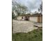 Home with concrete driveway, generator, and outdoor trashcans at 5774 N Ewing St, Indianapolis, IN 46220