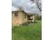 An exterior side view of the home's covered patio with outdoor seating at 5774 N Ewing St, Indianapolis, IN 46220