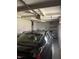 Garage features a black car with storage against the back wall and overhead lighting at 5774 N Ewing St, Indianapolis, IN 46220