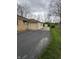 The property includes an attached garage and additional storage shed at the end of a long asphalt driveway at 5774 N Ewing St, Indianapolis, IN 46220