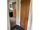 Hallway with wood doors and dark tile that leads into an office space at 5774 N Ewing St, Indianapolis, IN 46220
