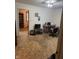 A living room featuring a black computer desk, TV, and a hallway to another room at 5774 N Ewing St, Indianapolis, IN 46220