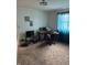 A living room featuring a black computer desk, a TV, a dark rolling chair, and light-colored curtains at 5774 N Ewing St, Indianapolis, IN 46220
