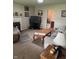 Cozy living room featuring a fireplace, comfortable seating, and a wood coffee table on neutral colored carpet at 5774 N Ewing St, Indianapolis, IN 46220