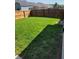 Lush backyard featuring green lawn and a wood privacy fence, perfect for outdoor activities and relaxation at 5912 Accent Dr, Indianapolis, IN 46221