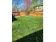 Backyard featuring a lush lawn, stone firepit, and wood fence creating a private outdoor space at 5912 Accent Dr, Indianapolis, IN 46221