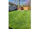 Spacious backyard with lush lawn, wood deck, and cozy seating area, perfect for outdoor gatherings at 5912 Accent Dr, Indianapolis, IN 46221