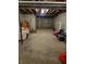 Basement with unfinished floors and walls featuring an exposed rafter ceiling and concrete flooring at 5912 Accent Dr, Indianapolis, IN 46221