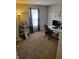 Bright bedroom featuring neutral walls, carpet, home office and workout space by a window at 5912 Accent Dr, Indianapolis, IN 46221