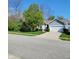 Charming home featuring a well-manicured lawn and a two-car garage at 5912 Accent Dr, Indianapolis, IN 46221