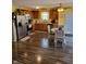 Bright kitchen with stainless steel appliances, wood cabinetry, and an adjacent dining area at 5912 Accent Dr, Indianapolis, IN 46221