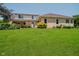 Expansive green backyard featuring a well-maintained lawn and the rear of the house at 6345 Canak Dr, Avon, IN 46123