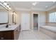 Bathroom with double sink vanity, tile floors, soaking tub, and walk-in closet at 6345 Canak Dr, Avon, IN 46123