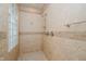 Modern tile shower with dual showerheads, glass block window, and neutral colors at 6345 Canak Dr, Avon, IN 46123