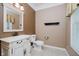 Half bathroom with elegant vanity, framed mirror, and neutral wall colors at 6345 Canak Dr, Avon, IN 46123