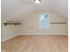 Attic bonus room featuring wood-look flooring, natural light, and built in shelving at 6345 Canak Dr, Avon, IN 46123