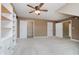 Spacious bonus room with carpet, a ceiling fan, multiple doorways, and white shelving units at 6345 Canak Dr, Avon, IN 46123