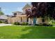 Brick home featuring a well-kept lawn, mature trees, and an inviting front porch at 6345 Canak Dr, Avon, IN 46123