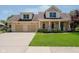 Charming brick two-story home with a two-car garage and well-manicured front lawn at 6345 Canak Dr, Avon, IN 46123