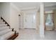 Bright and airy foyer featuring neutral tones, tile flooring, and staircase at 6345 Canak Dr, Avon, IN 46123