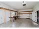 Spacious garage featuring a large open area, overhead door, and side door access at 6345 Canak Dr, Avon, IN 46123