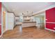 Bright eat-in kitchen featuring white cabinets, stainless steel appliances, and wood flooring at 6345 Canak Dr, Avon, IN 46123