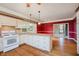 Spacious kitchen with wood flooring, tiled counters, and access to a living room at 6345 Canak Dr, Avon, IN 46123