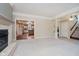 Open-concept living room with plush carpeting, fireplace, and view into the kitchen at 6345 Canak Dr, Avon, IN 46123